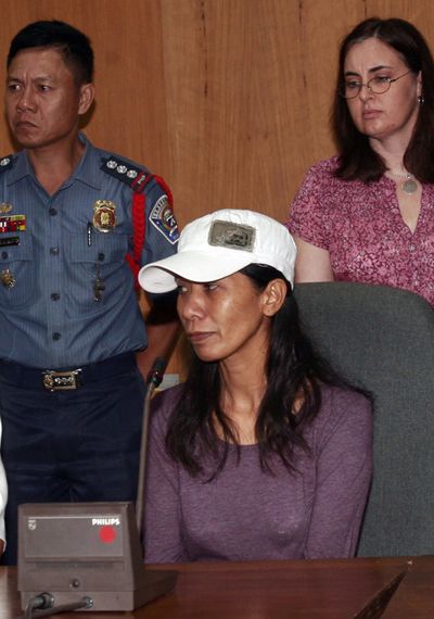 Freed hostage, Filipino American Gerfa Yeatts Lunsmann, center, listens as she is presented to reporters in Zamboanga City, southern Philippines Monday, Oct. 3, 2011. Muslim militants freed Lunsmann after 2 1/2 months in captivity in the southern Philippines but are still holding her 14-year-old son and a relative, authorities said Monday. She is now under the hands of FBI agents in the Philippines. (Associated Press)