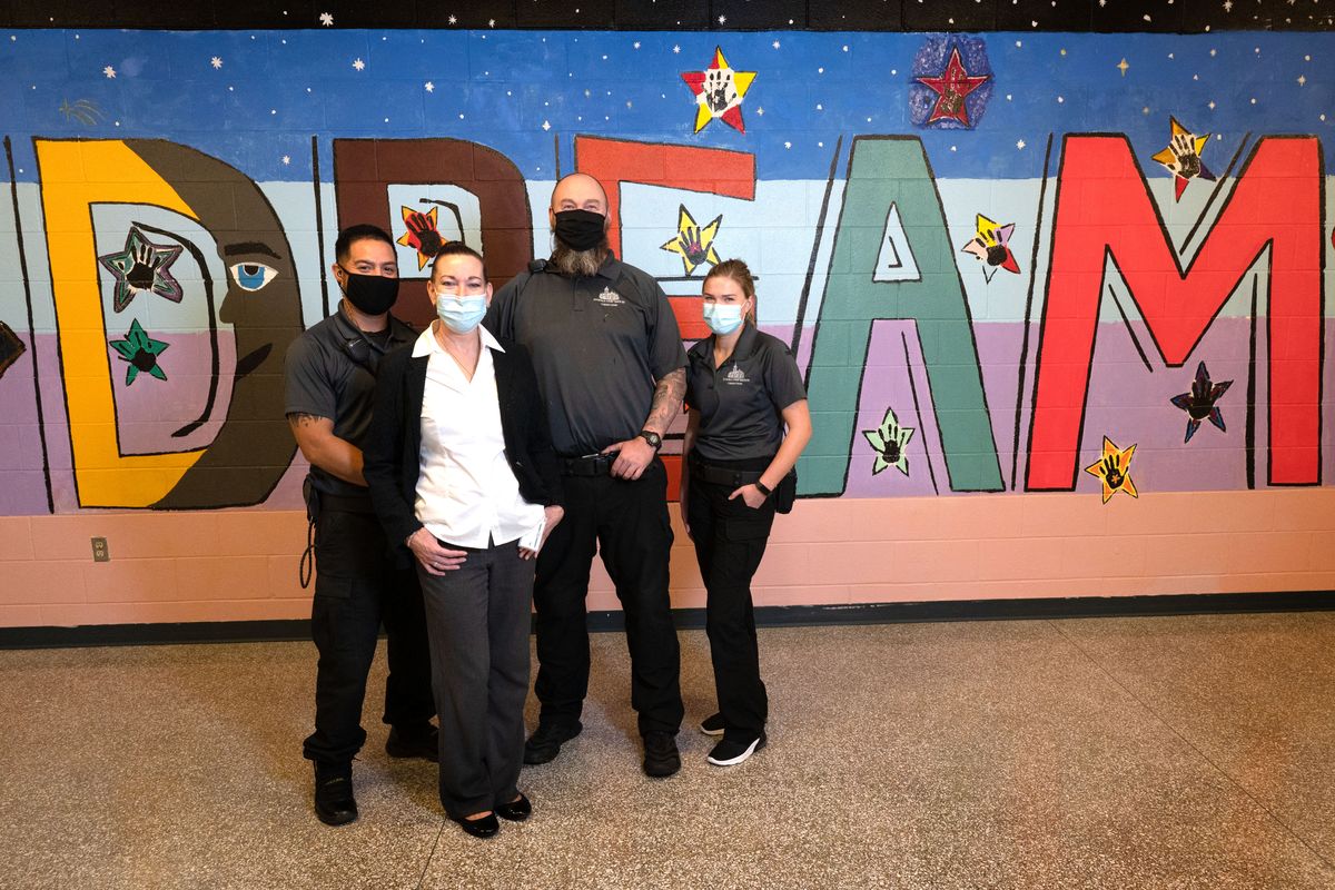 In front, Spokane Juvenile Detention manager Jennie Marshall and, in back from left, juvenile corrections officers Leo Avila, Adam Popp and Cheyenne Konard helped facilitate a mural art project to assist children at the detention center express themselves through art therapy.  (Colin Mulvany/The Spokesman-Review)