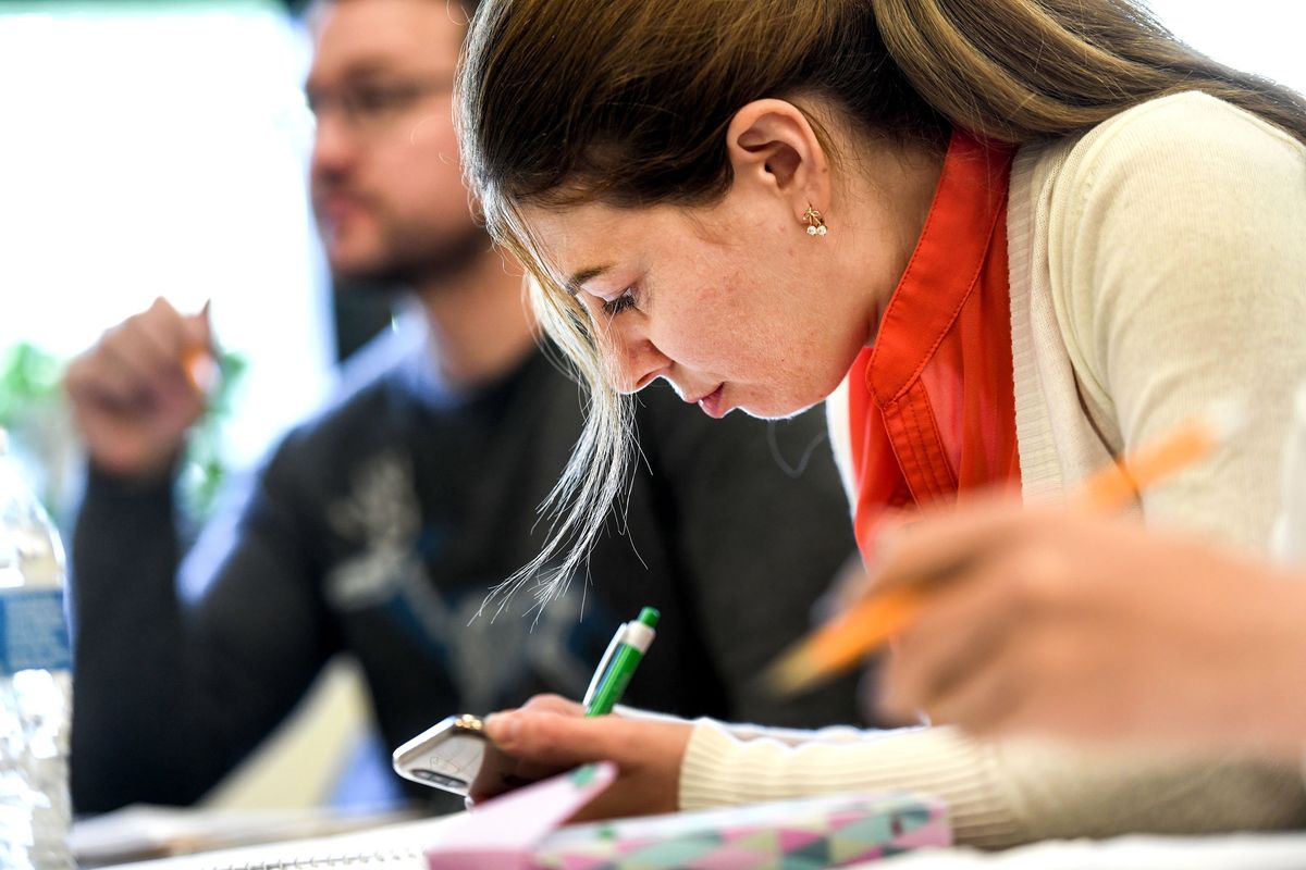 Alona Snihurova, right, and her husband Serhii Snihurov listen to instruction during class at Spokane Community College on Wednesday. The couple left Ukraine because of the war with Russia.  (Kathy Plonka/The Spokesman-Review)