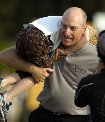 Happy winner Jim Furyk celebrates his 15th PGA Tour victory with son Tanner. (Associated Press)