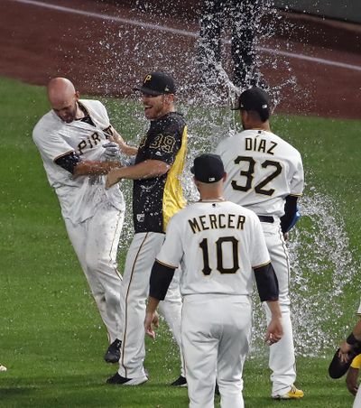 Pittsburgh Pirates' Jacob Stallings, left, is held by Chad Kuhl (39) as Elias Diaz (32) showers him while celebrating after hitting a walkoff single off Kansas City Royals relief pitcher Ben Lively in the bottom of the ninth of a baseball game in Pittsburgh, Monday, Sept. 17, 2018. (Gene J. Puskar / AP)