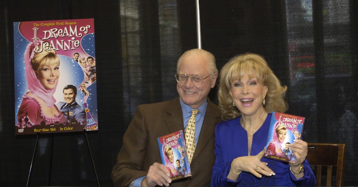 FILE - In this Wednesday, March 15, 2006 file photo, "I Dream of Jeannie" co-stars Barbara Eden and Larry Hagman pose for photos before signing copies of the newly-released first season DVD of their television show at a bookstore in New York.  Actor Larry Hagman, who for more than a decade played villainous patriarch JR Ewing in the TV soap Dallas, has died at the age of 81, his family said Saturday Nov. 24, 2012. (Jason Decrow / Associated Press)