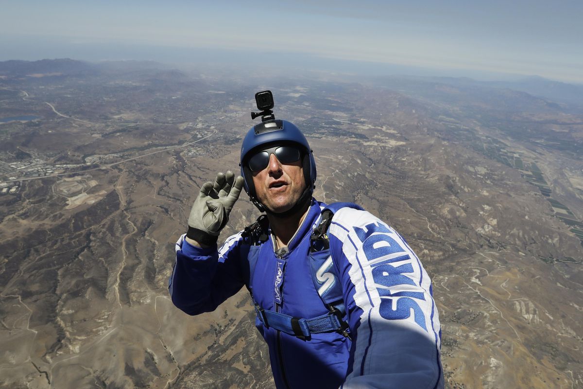 In this Monday, July 25, 2016 photo, skydiver Luke Aikins signals to pilot Aaron Fitzgerald as he prepares to jump from a helicopter in Simi Valley, Calif. (Jae C. Hong / Associated Press)