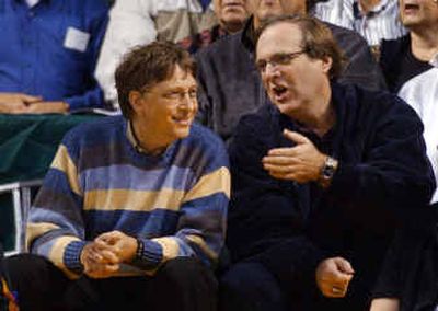 
Microsoft Chairman Bill Gates, left, chats with Portland Trail Blazers owner and Gates' former business partner, Paul Allen, during a game between the Blazers and Seattle SuperSonics in Seattle in 2003.
 (File photos/Associated Press / The Spokesman-Review)