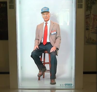 A hologram of Walmart founder Sam Walton holds court in front of a room in Bentonville, Ark. right before Thanksgiving. The piece comes at the head of a new wave of lifelike recreations of dead icons. MUST CREDIT: Washington Post photo by Steven Zeitchik.  (Steven Zeitchik/The Washington Post)