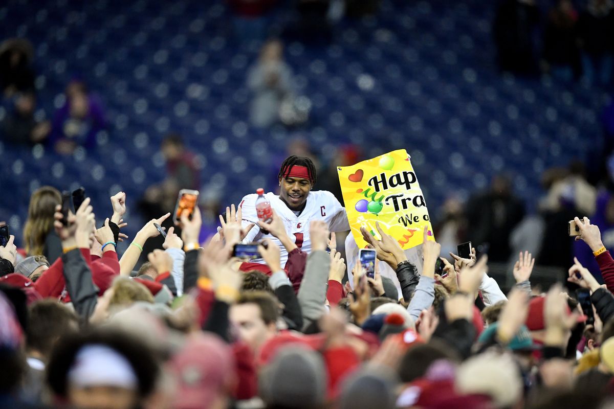 Washington State slotback Travell Harris is lifted by the crowd after WSU defeated the Washington Huskies to win the Apple Cup on Friday, Nov. 26 at Husky Stadium in Seattle.  (Tyler Tjomsland/The Spokesman-Review)