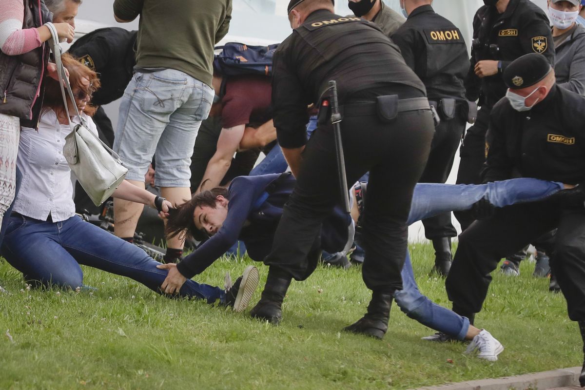 Police officers detain protesters during a rally against the removal of opposition candidates from the presidential elections in Minsk, Belarus, Tuesday, July 14, 2020. Election authorities in Belarus on Tuesday barred two main rivals of authoritarian leader Alexander Lukashenko from running in this summer