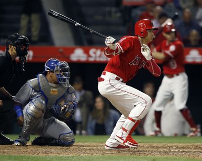 Los Angeles Angels' Shohei Ohtani, right, hits a single to right with Kansas City Royals catcher Salvador Perez and home plate umpire Gabe Morales, left, watching during the sixth inning of a baseball game in Anaheim, Calif., Monday, June 4, 2018. (Alex Gallardo / AP)