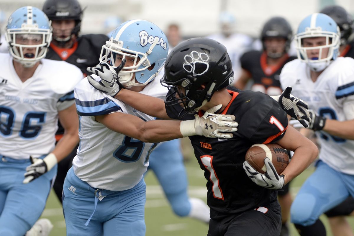 Lewis and Clark running back Camryn Schon, right, tries to discourage Central Valley’s Terrell Harrison. (Jesse Tinsley)