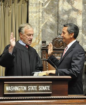OLYMPIA -- Dino Rossi takes the oath of office from Supreme Court Justice Jim Johnson to fill an vacancy in the state Senate. (Jim Camden)