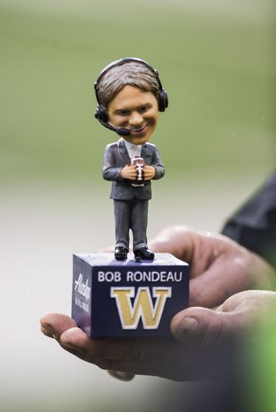 The University of Washington Honored long-time radio broadcaster Bob Rondeau with a bobble-head doll for fans attending the Apple Cup at Husky Stadium, Saturday, Nov. 25, 2017, in Seattle, Wash. Rondeau is retiring after 36 season with the Huskies. (Dan Pelle / The Spokesman-Review)