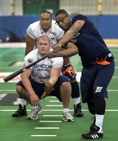 Trading sports: Spokane Shock football players try their hand at the national pastime in a pickup baseball game before practice at the team’s training facility Tuesday in Spokane Valley. Defensive lineman Diyral Briggs takes a swing at a rubber ball as offensive lineman Tyrone Novikoff plays catcher and offensive lineman Chris Pino umpires. The Shock play the Arizona Rattlers, the Arena Football League’s top-ranked team, Saturday in Phoenix. (Dan Pelle)