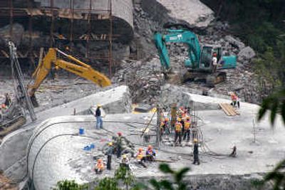 
Workers prepare explosives to demolish the ruins of a collapsed bridge in Hunan province. Associated Press
 (Associated Press / The Spokesman-Review)