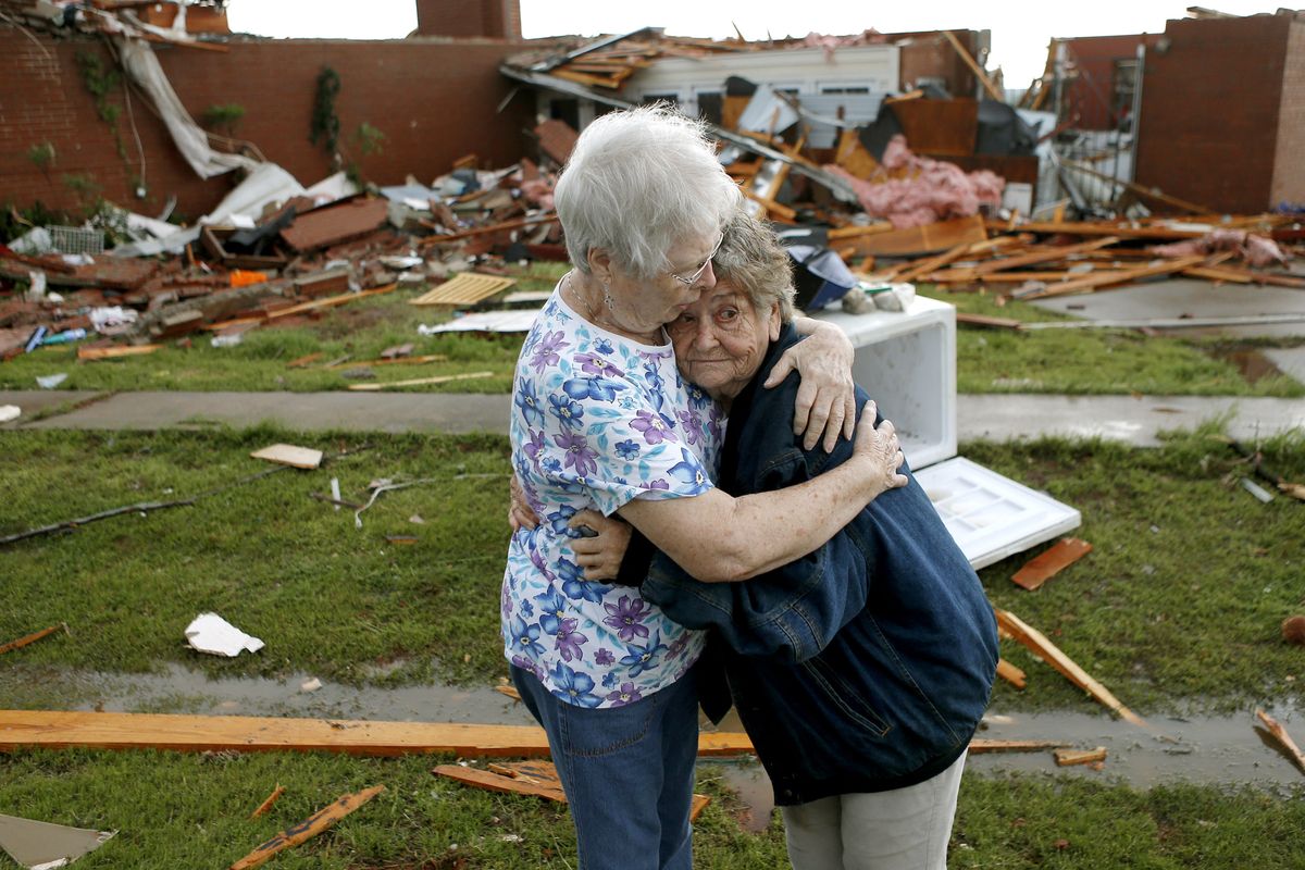 Jerry Dirks, at right, hugs friend Earlene Langley after a tornado hit Dirks’ home near Carney, Okla., on Sunday. Dirks was in her cellar when the tornado hit. (Associated Press)