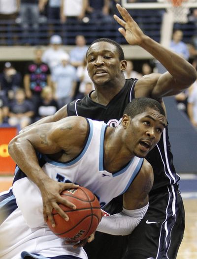 San Diego's Brandon Johnson, foreground, tries to drive past the defense of Gonzaga's Demetri Goodson, background, during the second half of an NCAA college basketball game Saturday, Jan. 16, 2010 in San Diego. Gonzaga won 68-50. (Denis Poroy / Associated Press)