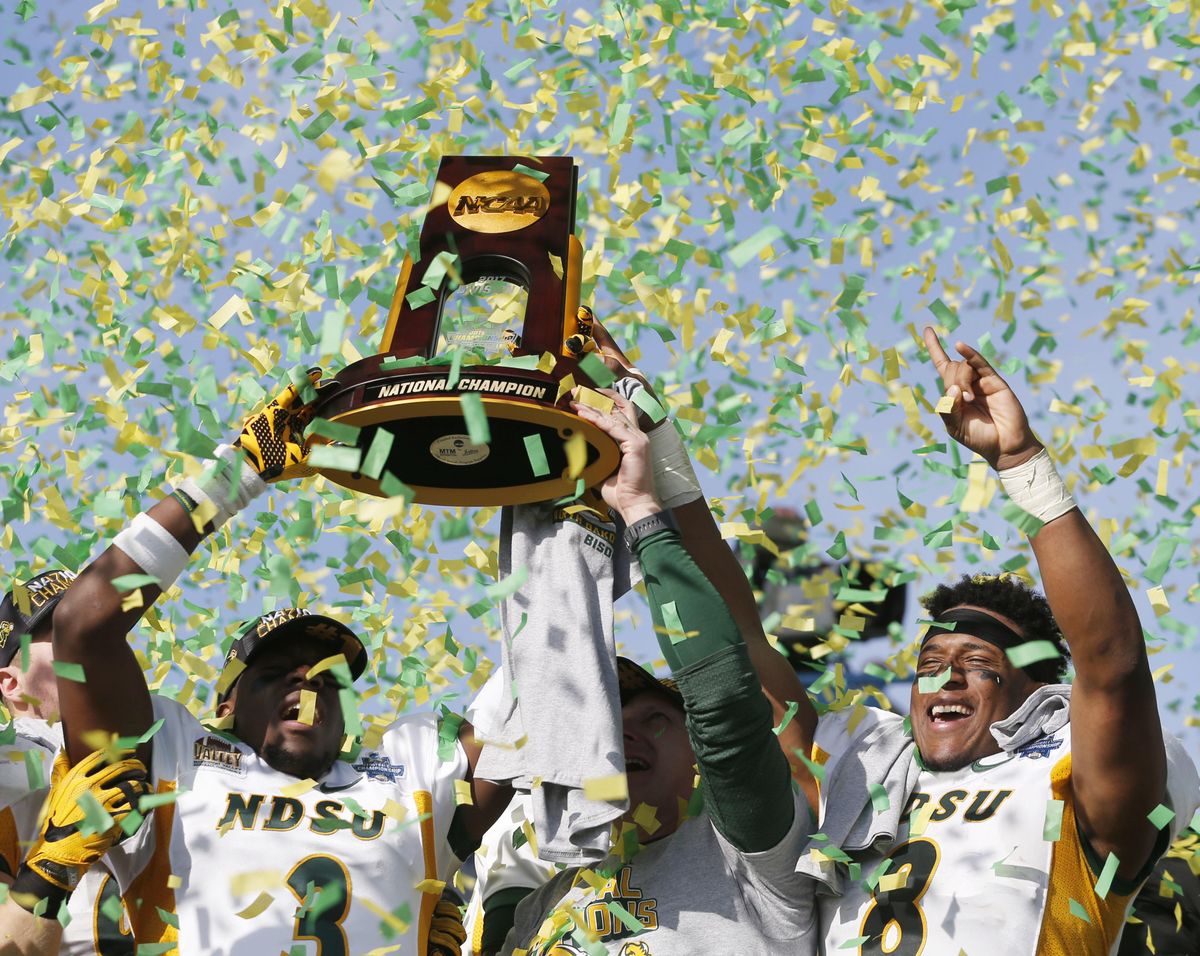 North Dakota State safety Tre Dempsey (3), head coach Chris Klieman and running back Bruce Anderson (8) celebrate after defeating James Madison 17-13 in the FCS championship  at Toyota Stadium in Frisco, Texas,  on Jan. 6, 2017. (Vernon Bryant / AP)