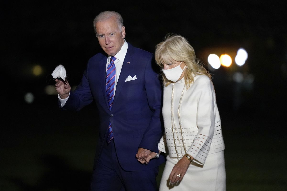 President Joe Biden waves as he and first lady Jill Biden walk on the South Lawn of the White House after stepping off Marine One, Thursday, Oct. 21, 2021, in Washington. The Bidens are returning from a CNN town hall in Baltimore. (Patrick Semansky)