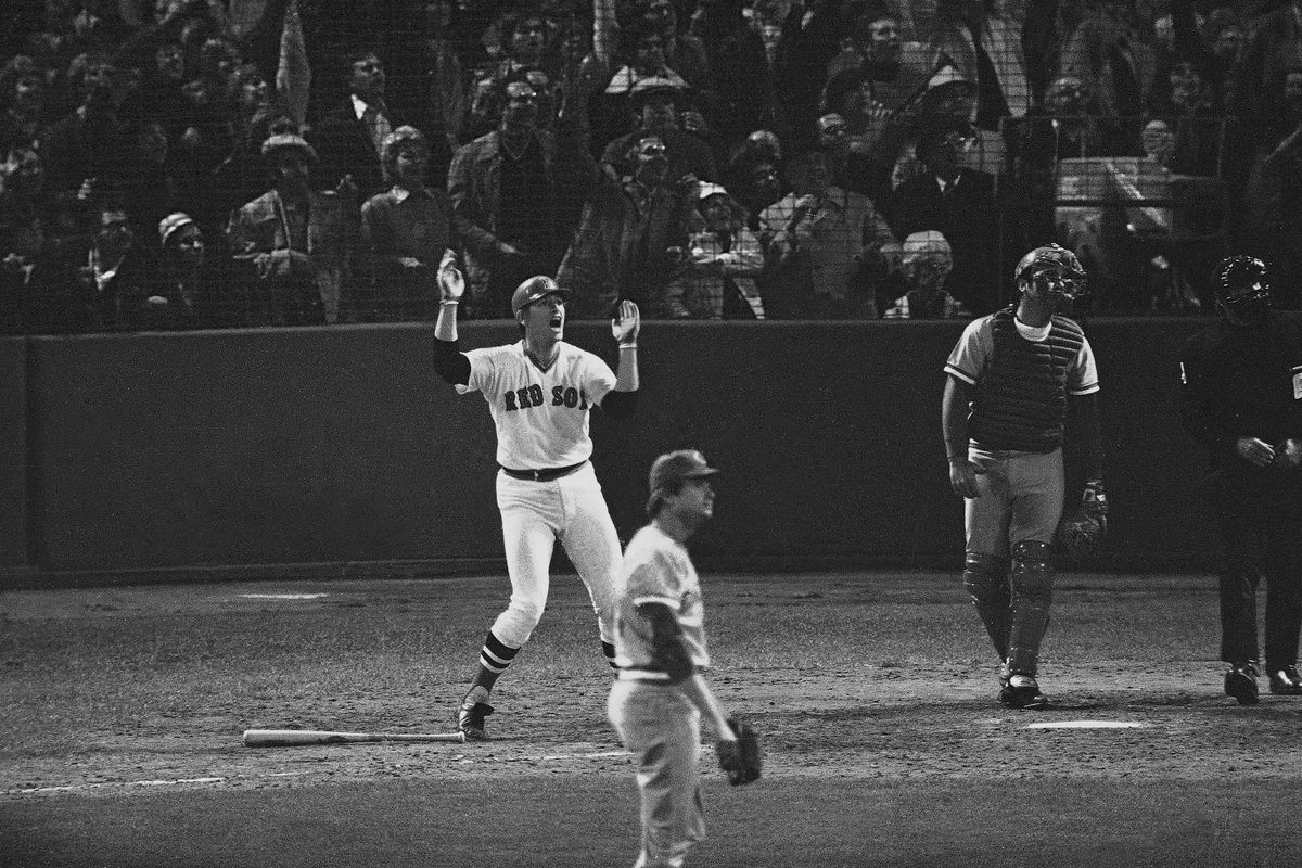 Boston’s Carlton Fisk waves arms to keep home run fair in 1975 Series. (Associated Press)