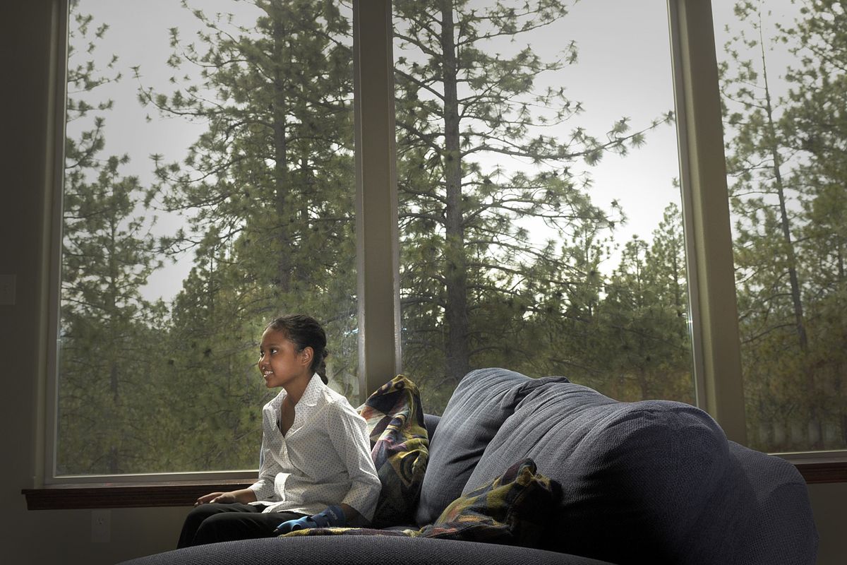 Keonnah Hinton sits by the front window of her family home in Spokane on Monday. (Christopher Anderson)