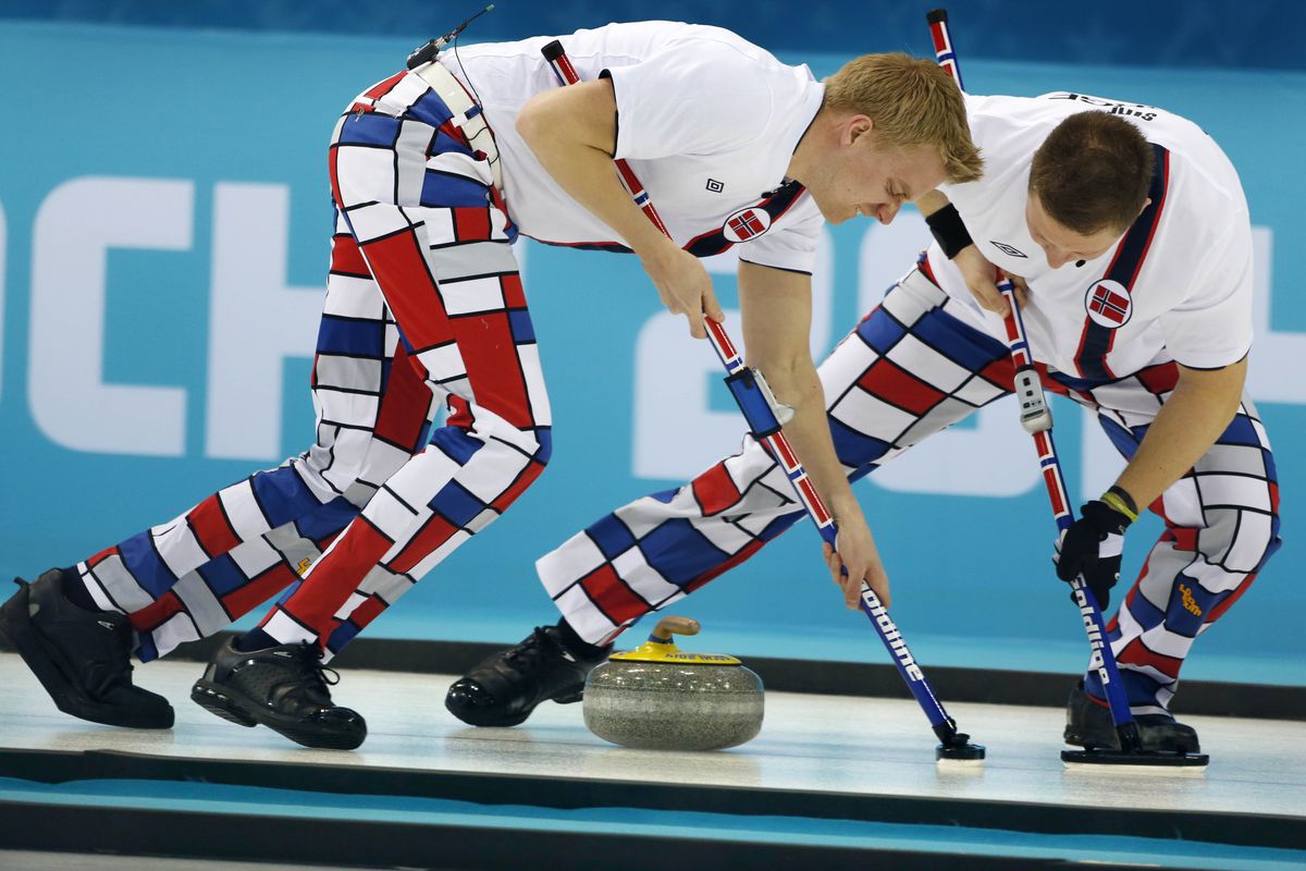 Norway’s Haavard Vad Petersson, left, and Christoffer Svae sweep with flair in 7-4 win over Team USA at the 2014 Winter Olympics. (Associated Press)