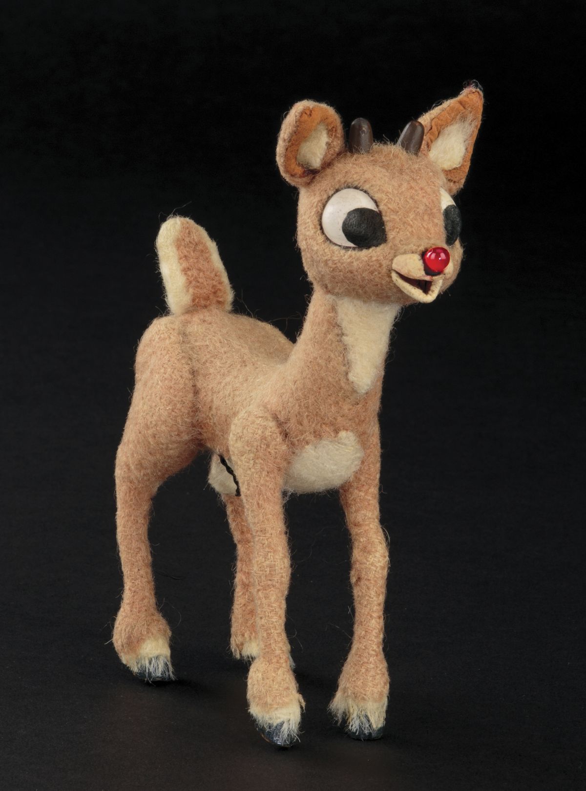 This image released by Profiles in History shows a Rudolph reindeer puppet used in the filming of the 1964 Christmas special “Rudolph the Red-Nosed Reindeer.” The soaring reindeer and Santa Claus figures who starred in in the perennially beloved stop-motion animation Christmas special “Rudolph the Red Nosed Reindeer” are going up for auction.Auction house Profiles in History announced Thursday that a 6-inch-tall Rudolph and 11-inch-tall Santa used to animate the 1964 TV special are being sold together in the auction that starts Nov. 13 and are expected to fetch between $150,000 and $250,000.  (HONS)