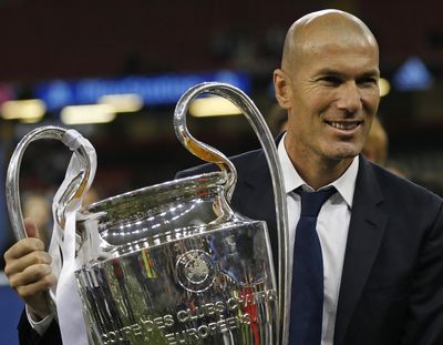 Real Madrid’s head coach Zinedine Zidane celebrates with the trophy at the end of the Champions League soccer final between Juventus and Real Madrid at the Millennium Stadium in Cardiff, Wales, Saturday, June 3, 2017. Real won the match 4-1. (Frank Augstein / Associated Press)
