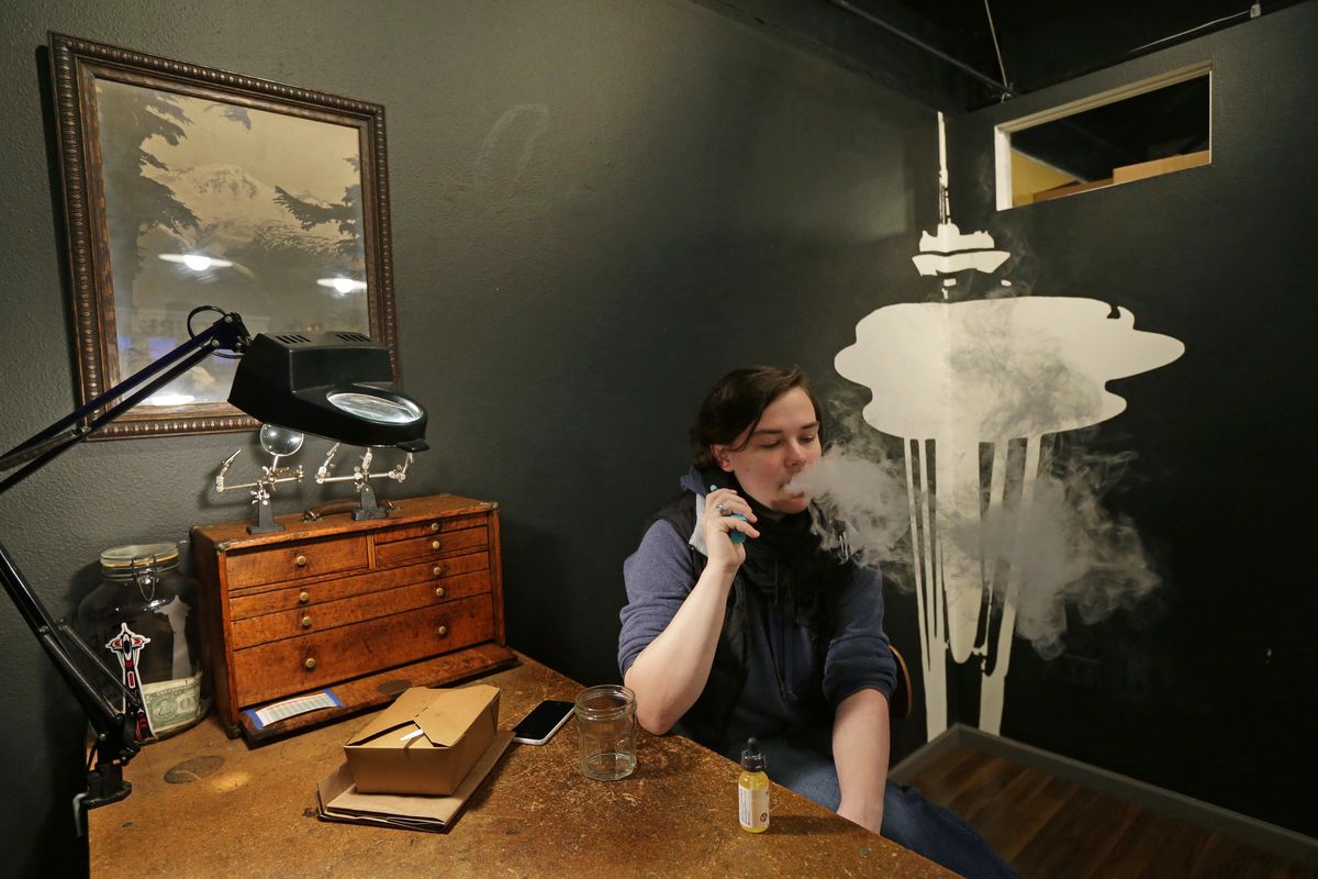 In this March 15, 2017, photo, Becca Blackwell vapes after taking a lunch break in the Future Vapor store in Seattle. (Ted S. Warren / Associated Press)