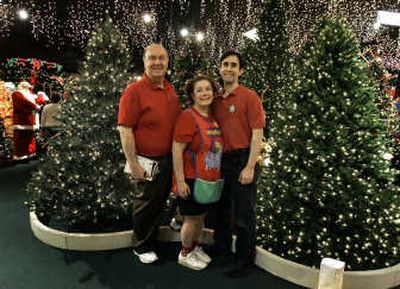 
Bob Frank, left, his wife, Rita, and son Josh pose in the Christmas tree forest at their store Robert's Christmas Wonderland in Clearwater, Fla. Frank sells Christmas merchandise despite living in a warm, beach community.Associated Press
 (Associated Press / The Spokesman-Review)