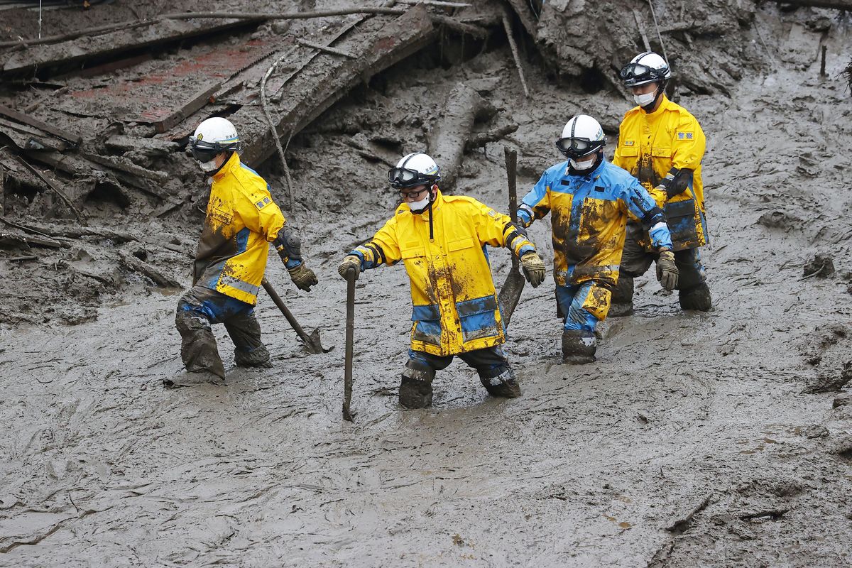 Rescuers conduct a search operation at the site of a mudslide at Izusan in Atami, Shizuoka prefecture, southwest of Tokyo, Sunday, July 4, 2021. More than 1,000 soldiers, firefighters and police on Sunday waded through a giant mudslide that ripped through the resort town as it swept away houses and cars.  (SUB)
