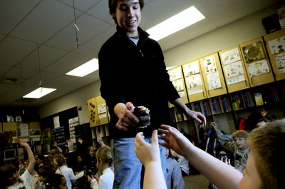 Lake City High School senior Beau Lee hands out cupcakes to students at Holy Family Catholic School on  Feb. 20  as a thank-you for their prayers for him during his recovery. Lee was injured in October 2008 after a fall from a balcony. (Kathy Plonka / The Spokesman-Review)