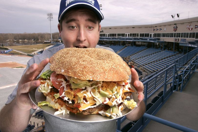 ORG XMIT: MIGRA101 Josh Kowalczyk, an intern with the West Michigan Whitecaps, in Comstock Park, Mich. poses for a photo March 24, 2009. The $20 burger will feature a sesame-seed bun made from a pound of dough, five 1/3-pound beef patties, five slices of cheese, nearly a cup of chili and liberal doses of salsa and corn chips. (AP Photo/The Grand Rapids Press, Rex Larsen) (Rex Larsen / The Spokesman-Review)