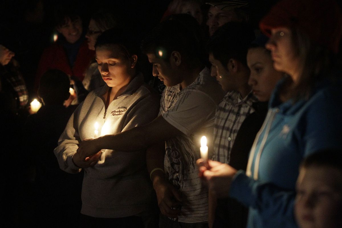 Mourners attend a vigil for the sons of Josh and Susan Powell on Sunday at Carson Elementary in Puyallup, Wash. Their 7-year- old, Charles, attended the school. (Associated Press)