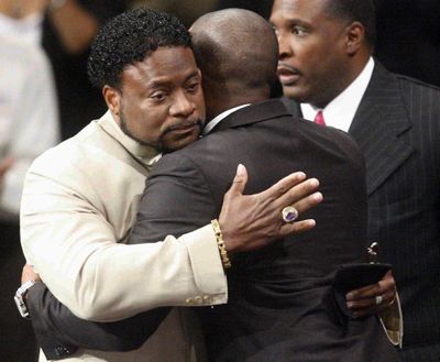 Bishop Eddie Long, left, embraces a friend Sunday at New Birth Missionary Baptist Church in Atlanta.  (Associated Press)