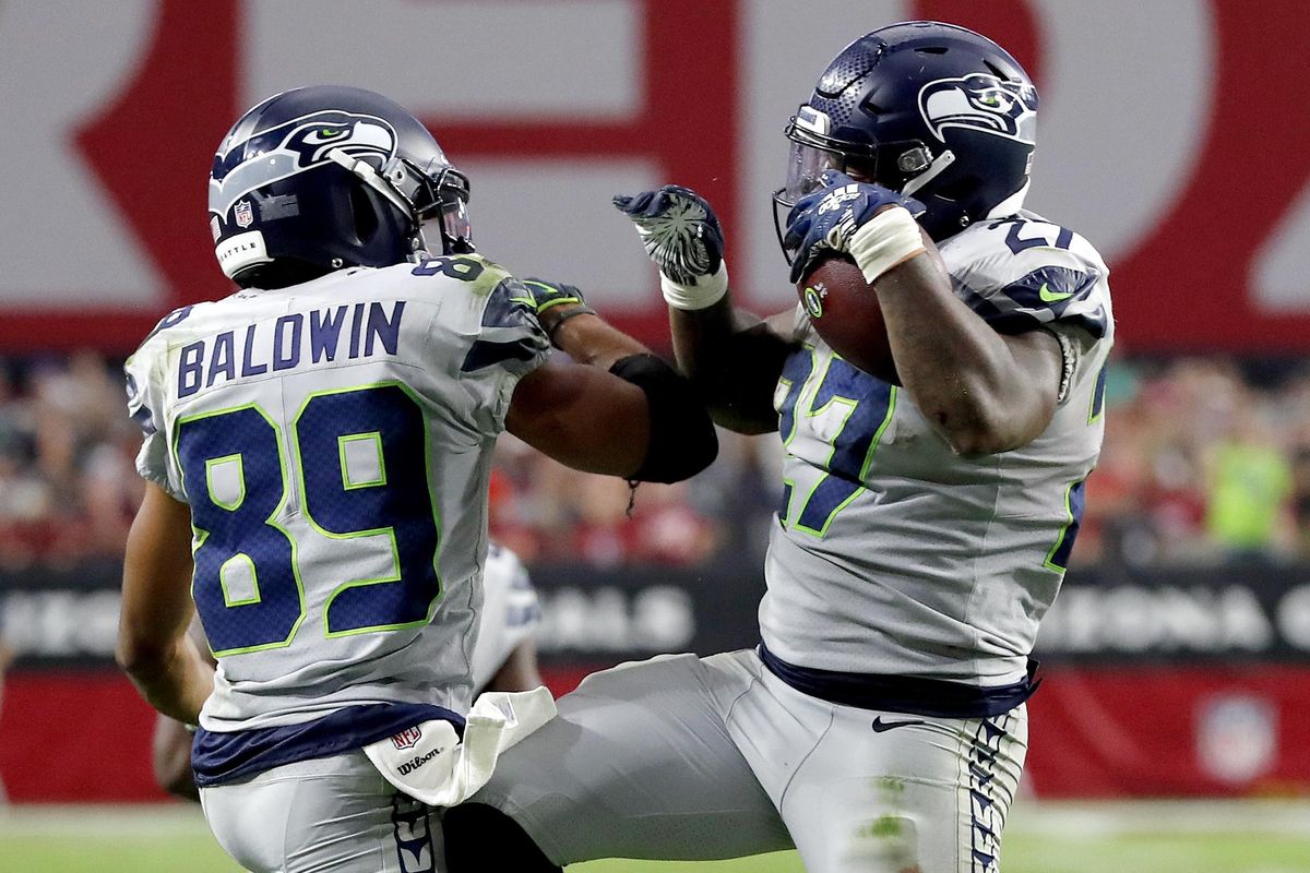 Seattle Seahawks running back Mike Davis (27) celebrates his touchdown with wide receiver Doug Baldwin (89) during the second half of an NFL football game against the Arizona Cardinals, Sunday, Sept. 30, 2018, in Glendale, Ariz. (Rick Scuteri / Associated Press)