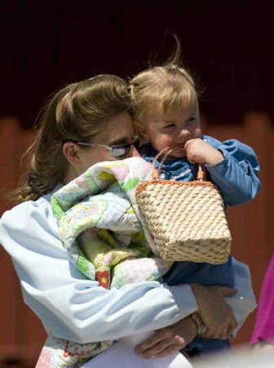 
A woman from the Fundamentalist Church of Jesus Christ of Latter Day Saints is reunited with her child  in Liverpool, Texas,  on Monday.  Associated Press
 (Associated Press / The Spokesman-Review)
