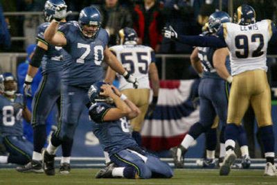 
Quarterback Matt Hasselbeck, kneeling, and the Seattle Seahawks agonized through three losses against the St. Louis Rams during the 2004 season. 
 (File/Associated Press / The Spokesman-Review)