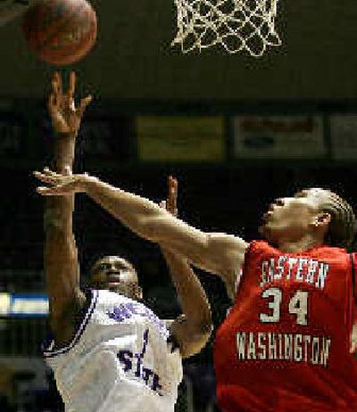 
Weber's Coric Riggs, left, scores two of his 19, this time over Kellen Williams.
 (Associated Press / The Spokesman-Review)