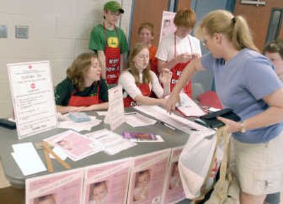 
Rose Kelly, 20 and Tess Kelly, 17, from left seated, check in Anne Frey at the Annual Frances Kelly Blood Drive  on May 26. Associated Press
 (Associated Press / The Spokesman-Review)