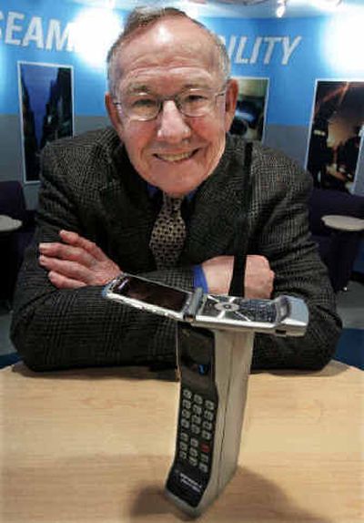 Rudy Krolopp, lead designer of the first cell phone, poses with Motorola's first cellular phone the DynaTAC8000X and their new Razr cell phone. Dubbed