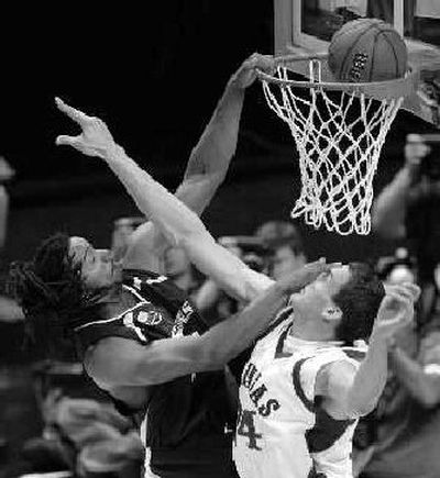 
Southern Illinois' Randal Falker dunks ball and Kansas' Sasha Kaun. Falker had 11 points in the loss. 
 (The Spokesman-Review)