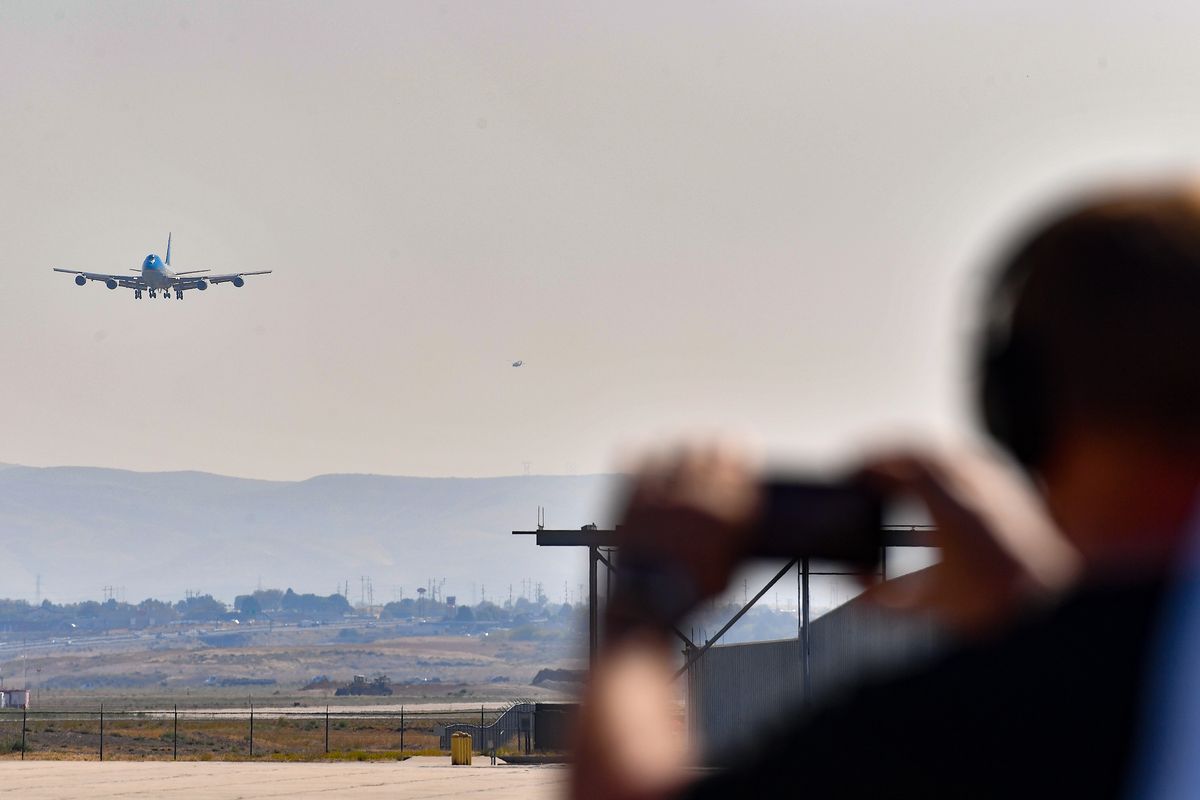 Media members shoot photos as Air Force One arrives on Monday, Sep 13, 2021, in Boise, ID. President Biden was in Boise for a briefing at the National Interagency Fire Center and to speak with Gov. Brad Little and Boise Mayor Lauren McLean.  (Tyler Tjomsland/The Spokesman-Review)