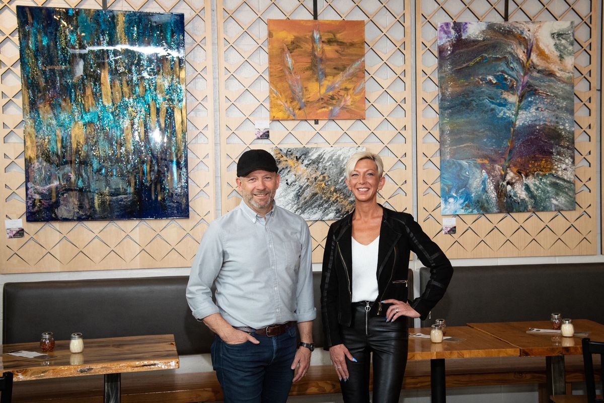 South Perry Pizza owner John Siok, left, is shown with current wall artist, Karen Case, inside South Perry Pizza at 1011 S. Perry St.  ( Paula Siok)