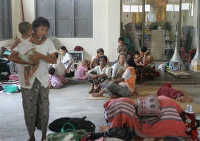 
Families who were displaced from last weekend's devastating cyclone take shelter at a monastery in Kyauktan Township in southern Myanmar on Thursday.  Associated Press
 (Associated Press / The Spokesman-Review)