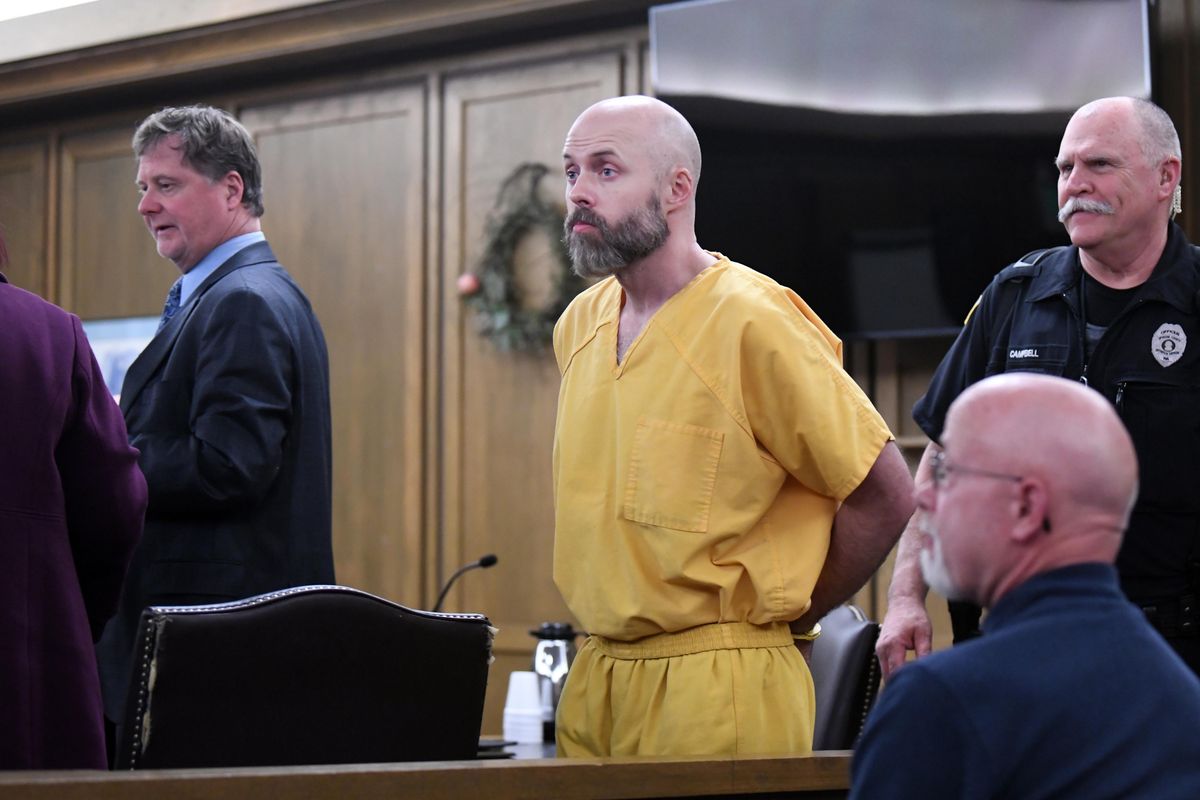 Former Spokane Police Officer Gordon Ennis, center, is led from a Spokane County courtroom Wednesday, April 25, 2018 after his sentencing on rape charges was postponed while he changes attorneys, from Rob Cossey, second from left, to Mark Vovos. He was convicted of raping a female police officer during a drunken party at another officers home. (Jesse Tinsley / The Spokesman-Review)
