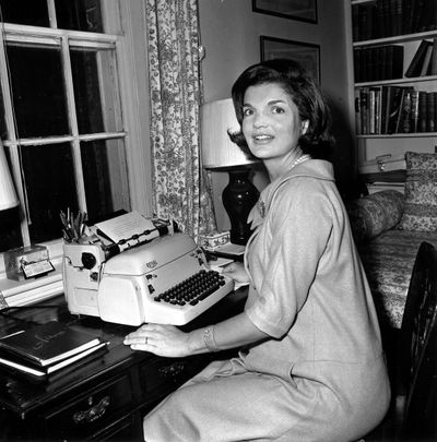 In this Oct. 5, 1960 AP file photo, Jacqueline Kennedy poses at her typewriter where she writes her weekly 