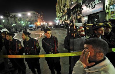 Egyptian police attend the scene outside the Hussein mosque in the Khan el-Khalili market following a blast in Cairo on Sunday.  (Associated Press / The Spokesman-Review)