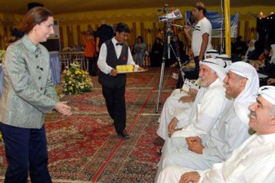
Legislature candidate Rula Dashti, left, talks to supporters Wednesday in Jabriya, Kuwait City. She is one of 28 females running for the legislature in the first election in which Kuwaiti women can vote. 
 (Associated Press / The Spokesman-Review)