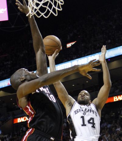 San Antonio Spurs' Gary Neal, right, sets up to take a shot as the Miami Heat's Joel Anthony makes the effort to block it. (Associated Press)