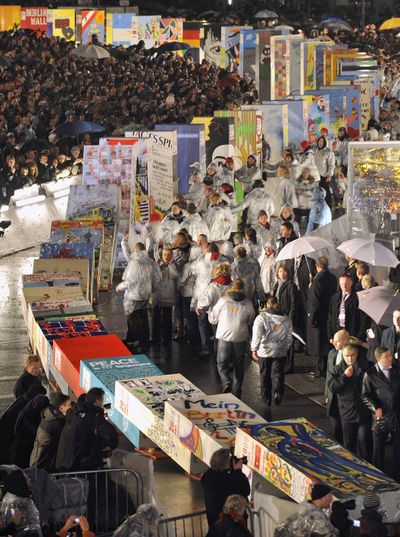 Giant dominos placed along the former border in front of the Brandenburg Gate fall Monday during commemorations of the 20th anniversary of the fall of the Berlin Wall. Associated Press photos (Associated Press photos / The Spokesman-Review)