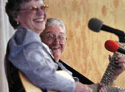 
Doug Reed, right, laughs with fellow musicians while jamming at the Cloverleaf Grange on  July 15 in Post Falls. At left is Ivy Deacon. Reed, a songwriter and auctioneer, throws the twice-monthly jam/dance. 
 (Jesse Tinsley / The Spokesman-Review)
